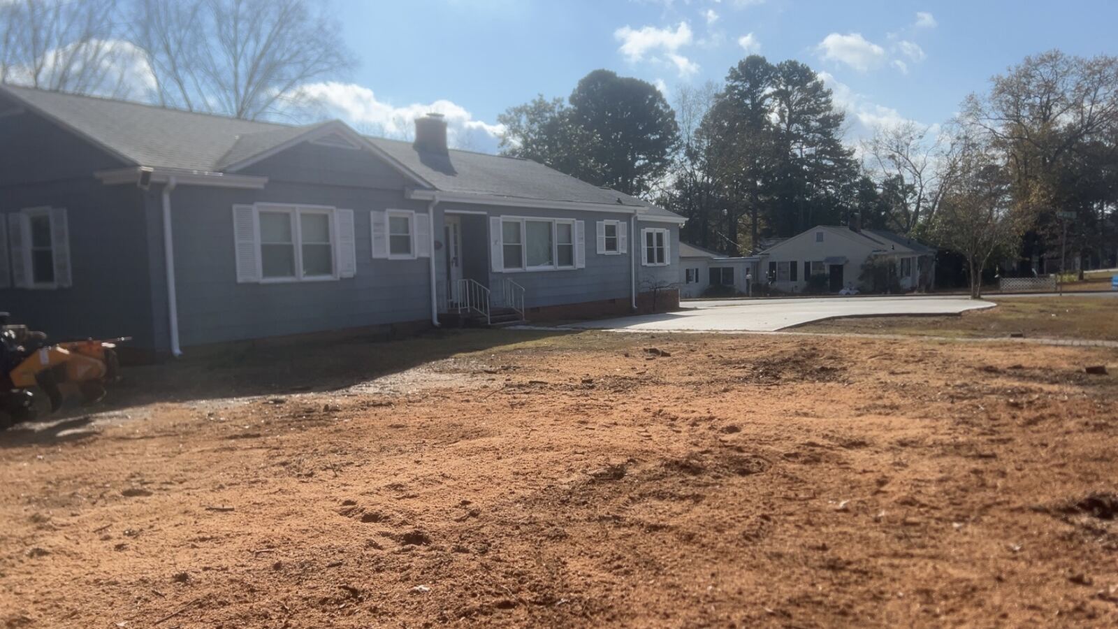 Front yard cleared and graded after tree removal, stump ground out